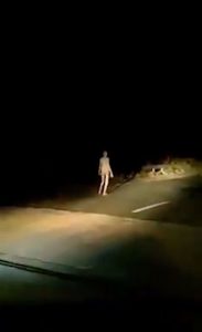 Alien walking on road